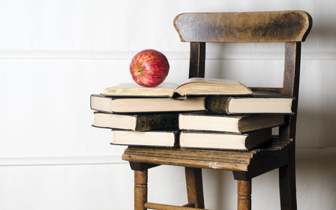 Classroom chair with apple and books